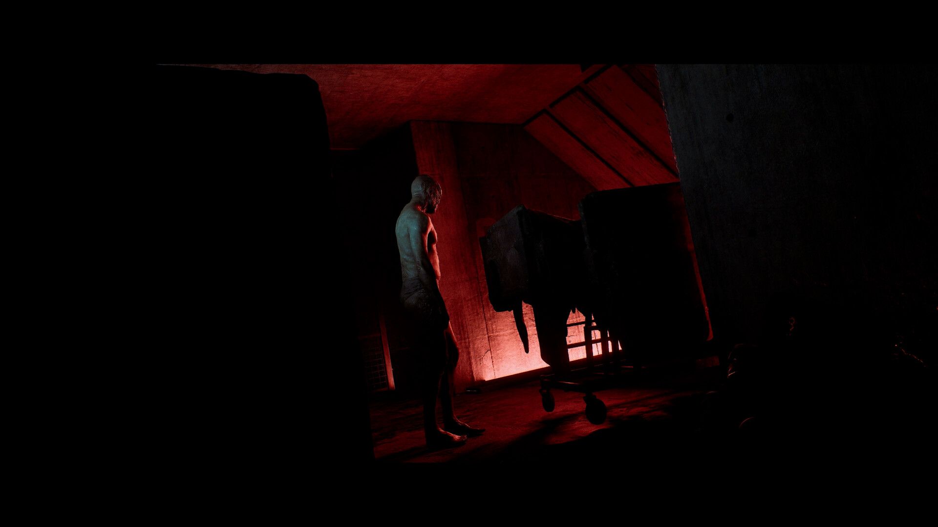 Simon Ordell standing in a red-lit industrial interior in SILENT HILL: Townfall